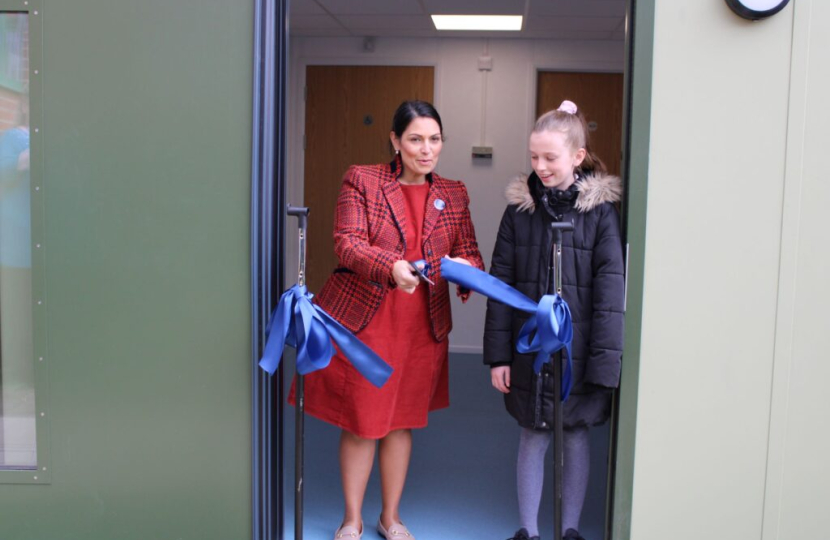 Priti cuts the ribbon to open the new classroom, alongside 11 year old Mia Scholey, Chair of the School Council.