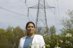 Priti Patel MP with existing pylons that demonstrate their dominant effect on the local environment